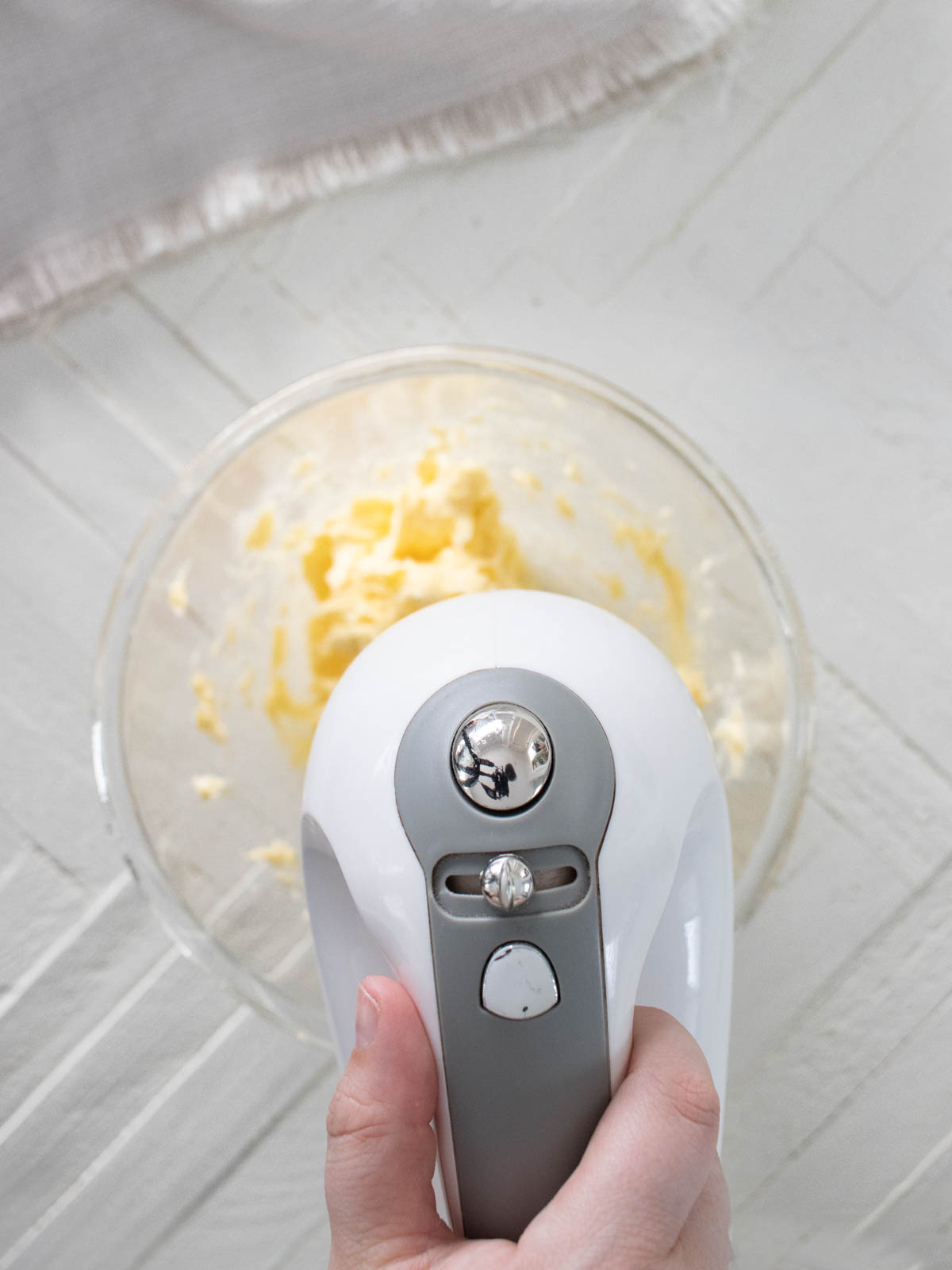 Hand mixer beating butter