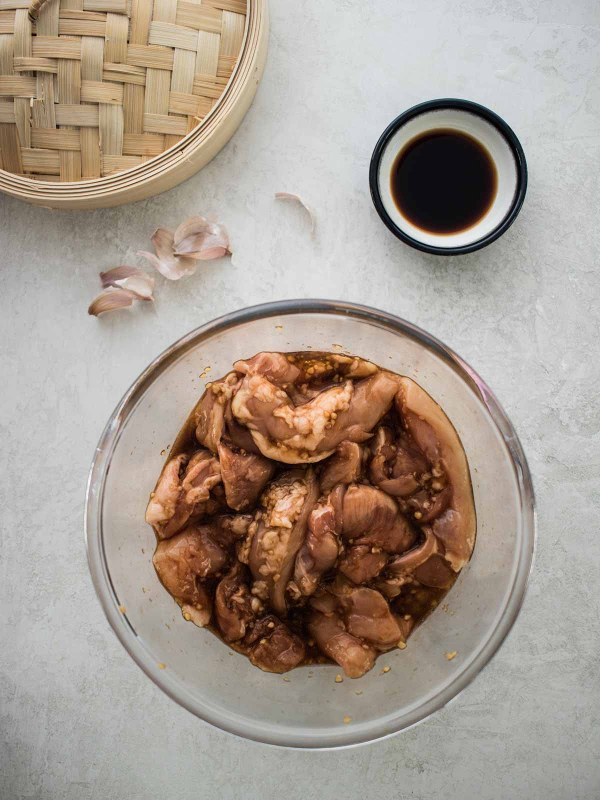 Chicken marinating in a bowl