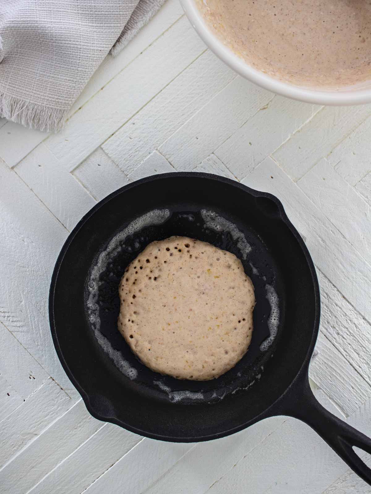 oatmeal pancake cooking in a pan